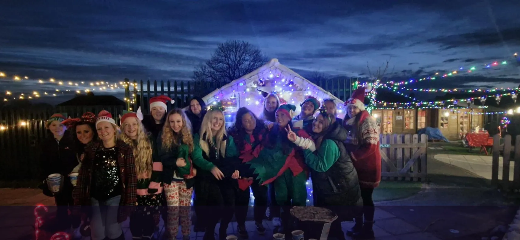 The nursery team gathered under the Christmas lights at Ready Steady Go Childcare Weston-super-Mare