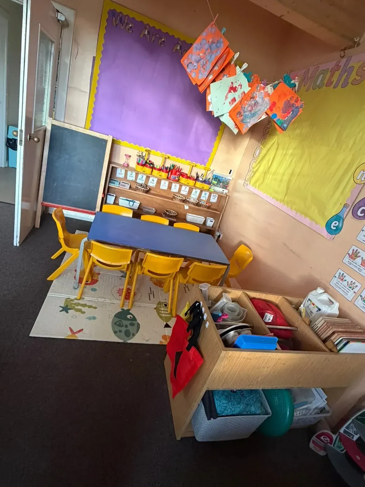 Maths and mark making corner with a chalkboard and painting display at the Ready Steady Go preschool in Milton