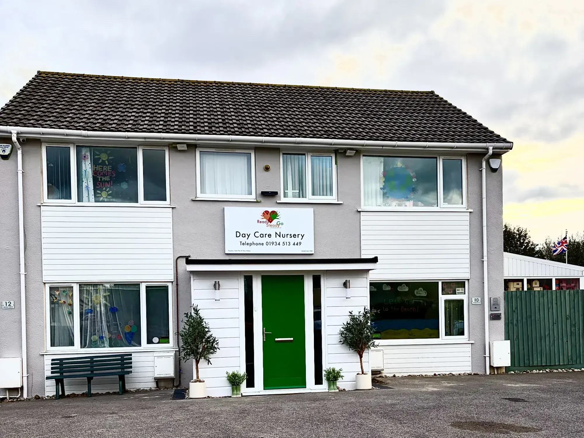 Front of Ready Steady Go Day Care Nursery on Mendip Avenue, Worle, with its green front door and nursery sign