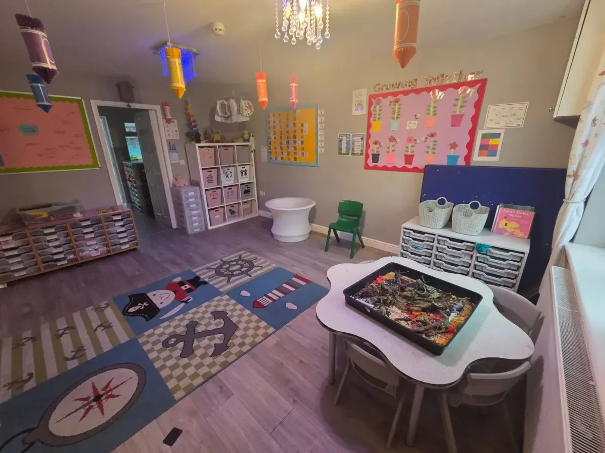 Playroom with a pirate rug, tuff tray and Growing Together display at Ready Steady Go Childcare Worle